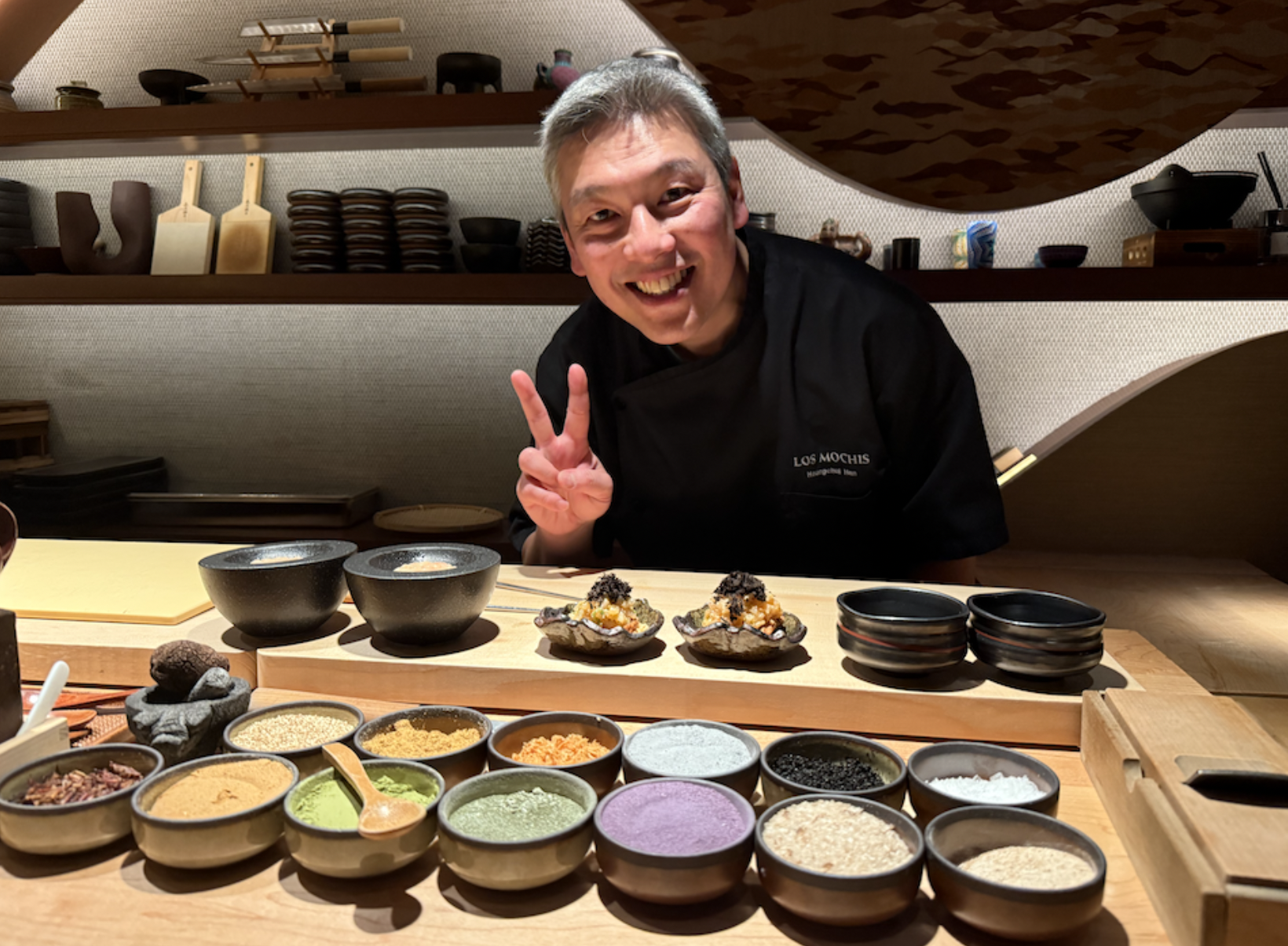 Omikaze chef over his little bowls of ingredients