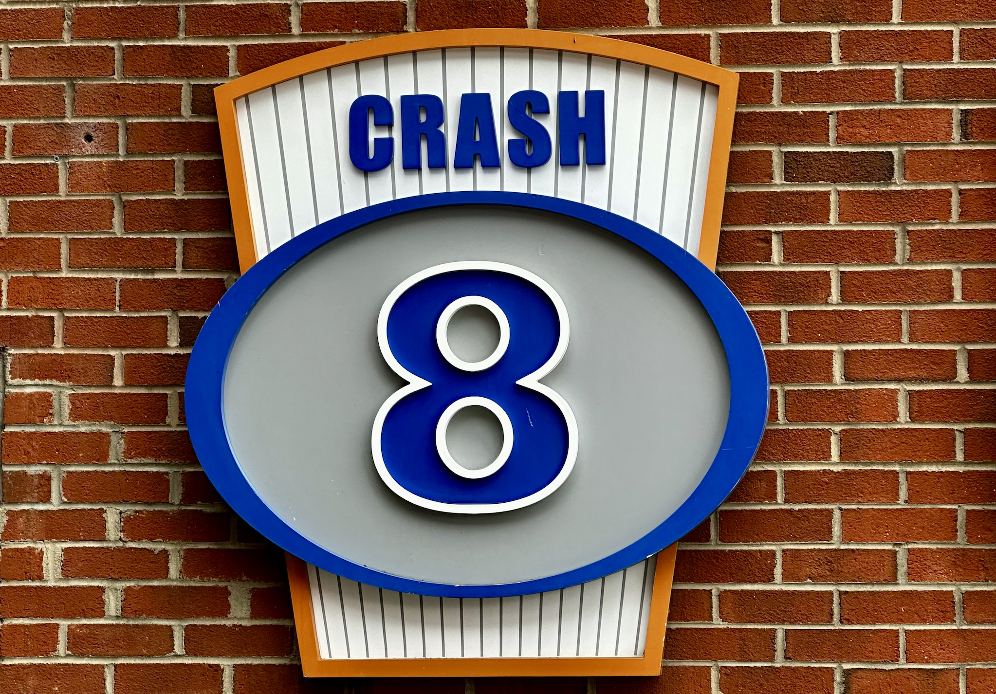 Retired number plaque -- number 8 -- with the name "Crash" at the top, for Crash Davis from the movie "Bull Durham."