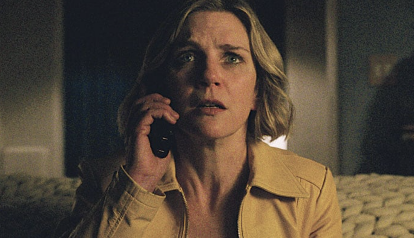 Rhea Seehorn holding a telephone and looking afraid in a screen shot from "Pluribus"