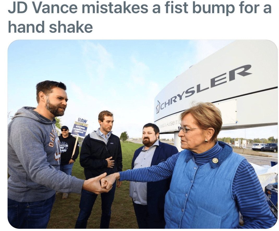 A woman giving J.D. Vance a fist-bump but he's grabbed her fist and is trying to give it a handshake