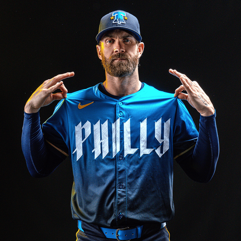 Bryce Harper in an electric blue uniform with "PHILLY" written on the chest in jagged letters