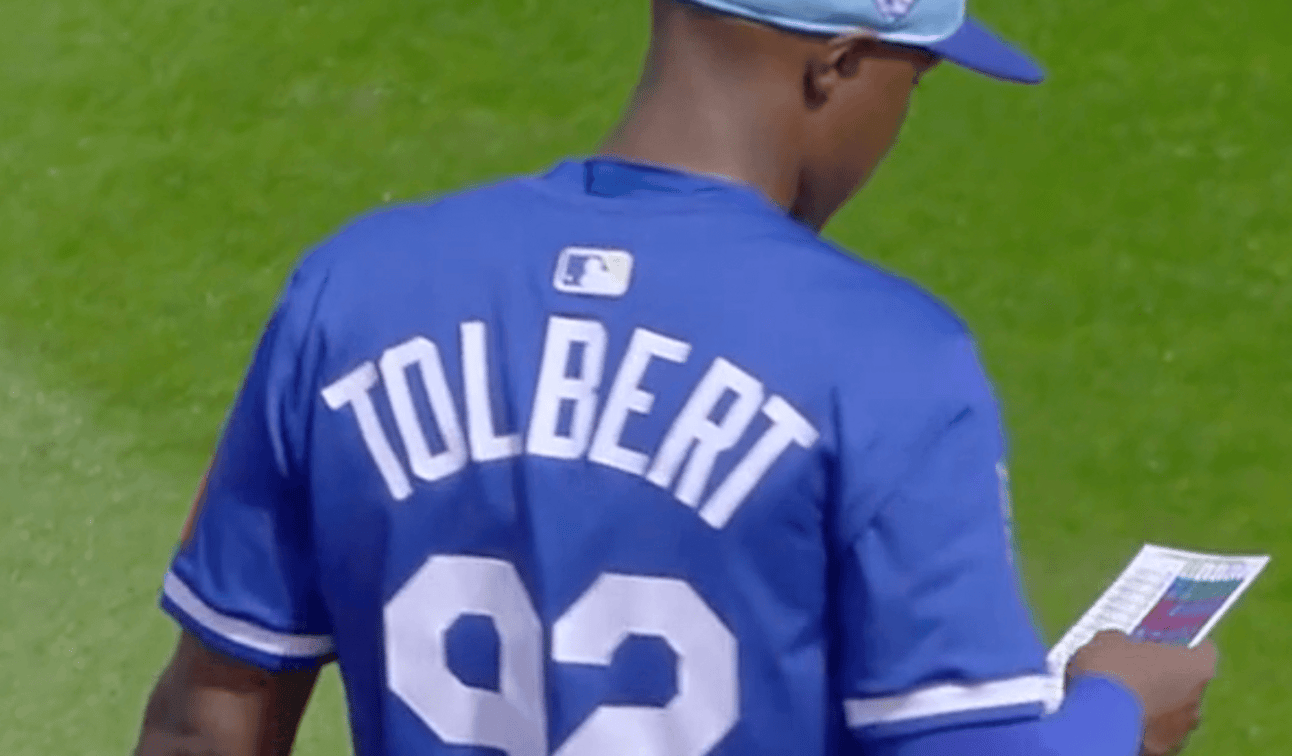 Royals player with large letters on the back of his uniform