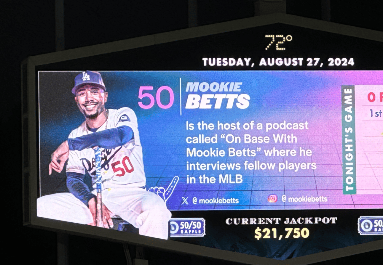 Dodger Stadium scoreboard showing a Mookie Betts fact about his podcast in which it refers to "fellow players in the MLB"