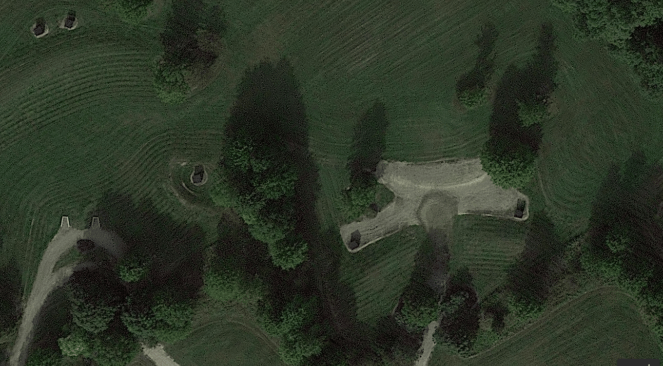Arial view of farmland with a scraped piece of land and maybe a structure