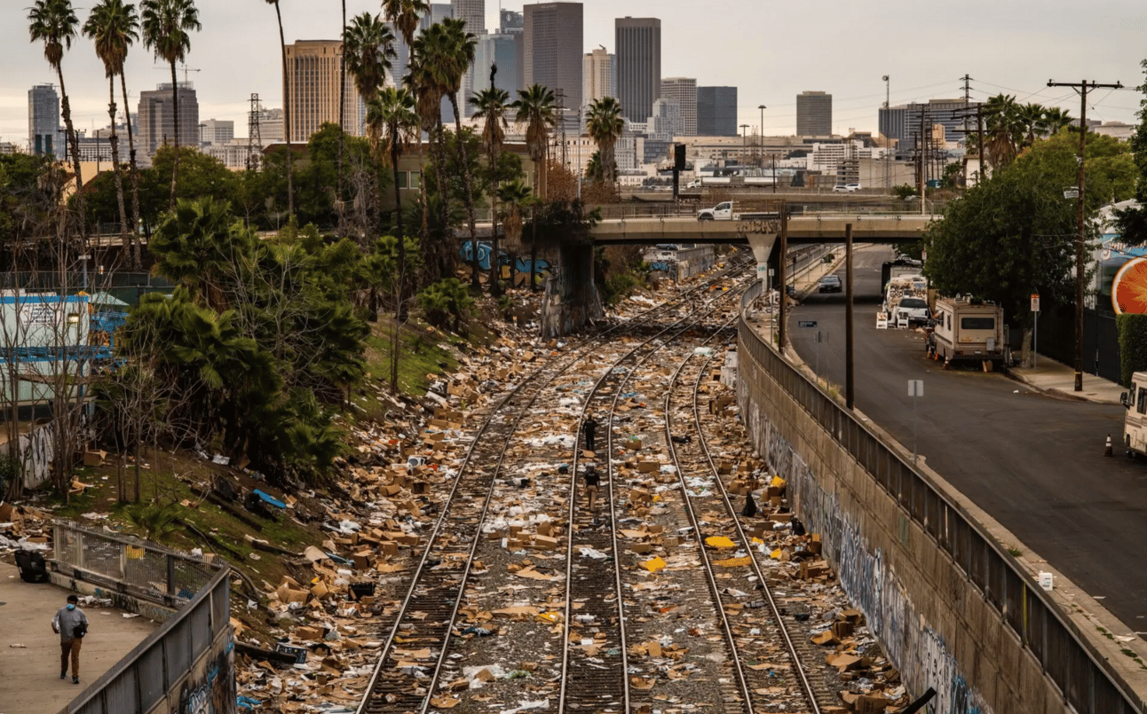 Train tracks completely littered with trash from packages stolen off of trains