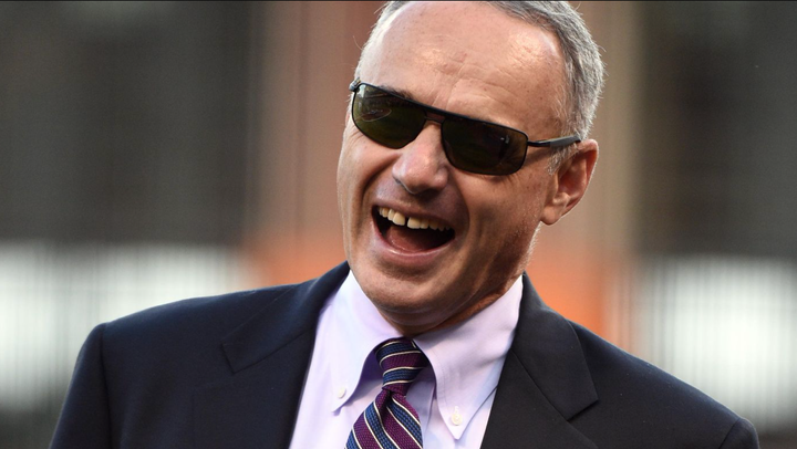 Rob Manfred wearing sunglasses and smiling like a big doof