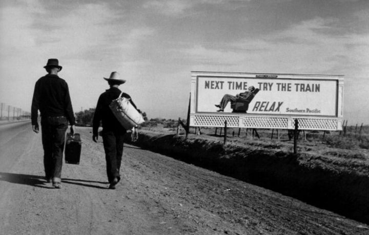 A billboard that says "Next Time Try the Train! Relax!"