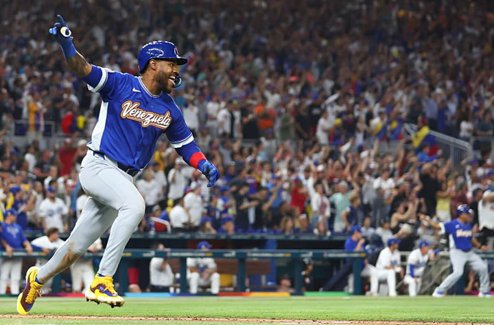 Maikel Garcia with his arm in the air after RBI single