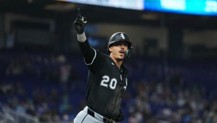 Miguel Vargas with one hand in the air after hitting a grand slam